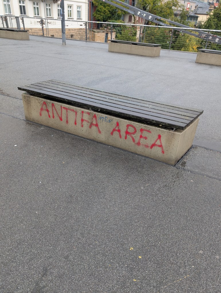 Graffiti on a bench on the chain bridge in Bamberg, Germany, that reads "Antifa Area"